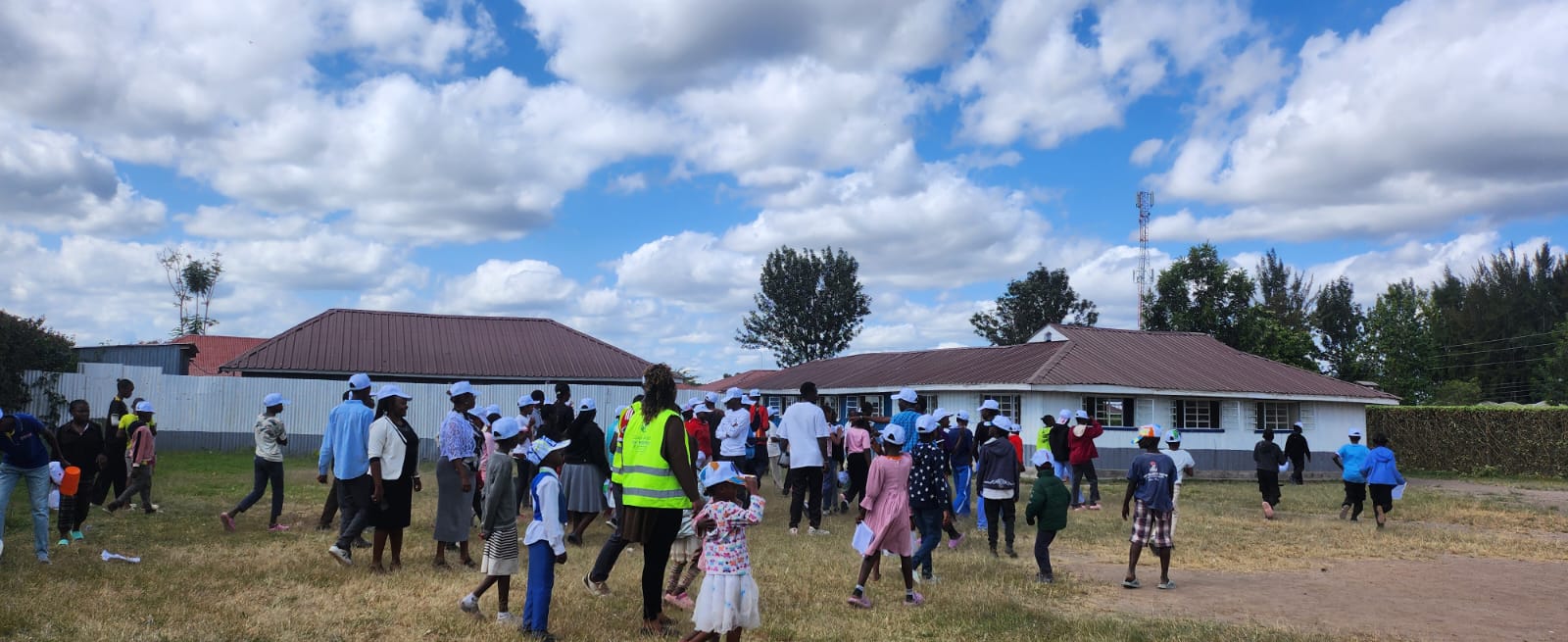 GRH Team with children marching in the field